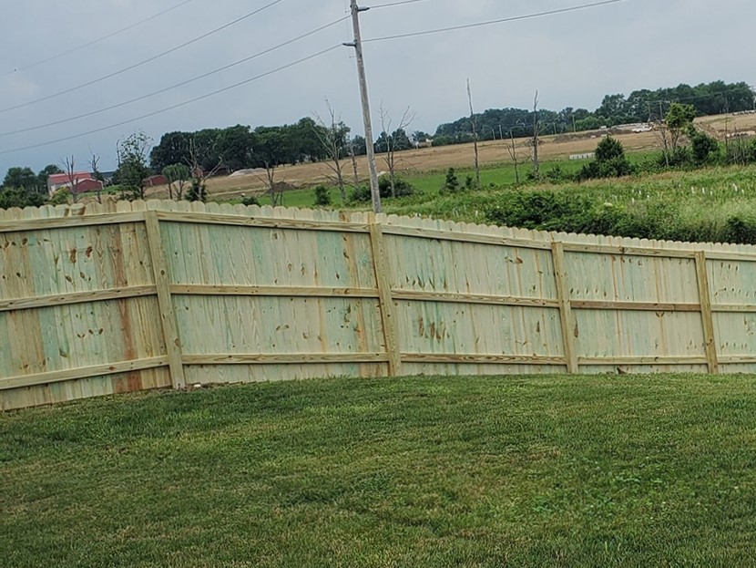 Photo of an Indianapolis, IN wood fence installed on hilly ground